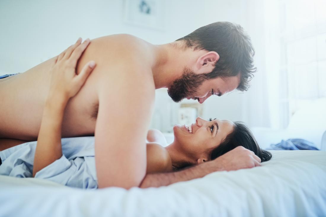 Couple communicating in bed about cervix penetration